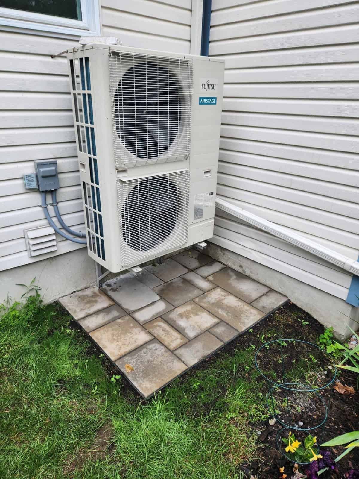 A heat pump outside of a house.