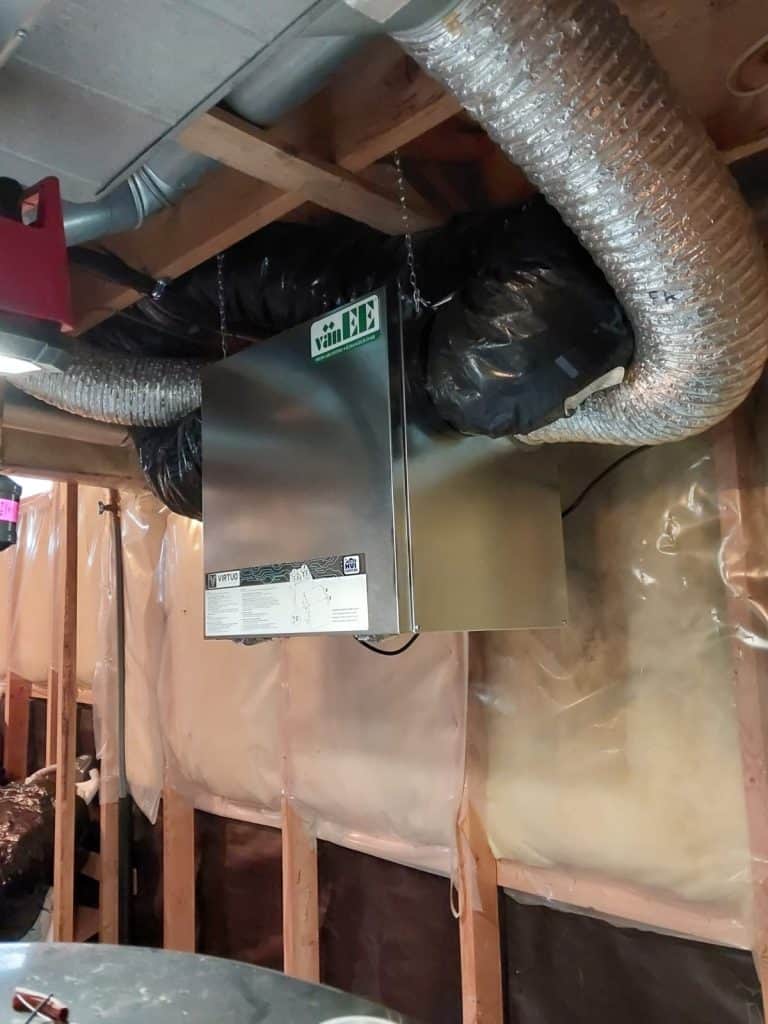 A room with a metal box and ducting.